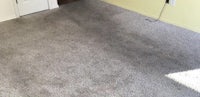 a room with a gray carpet and a door