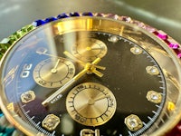 a close up of a watch with multi colored crystals