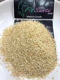 a bowl of sesame seeds on a table