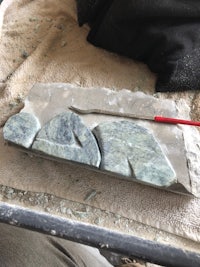 a piece of stone with a red tool on it