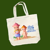 a tote bag with an image of two children on the beach