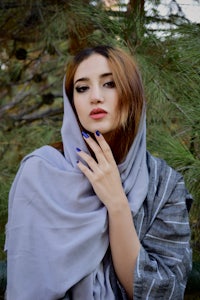 a beautiful woman wearing a gray scarf