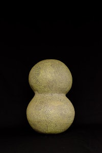 a yellow vase on a black background