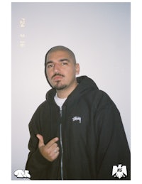 a man in a black hoodie posing for a picture