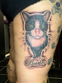 a tattoo of a cat with the word buster on it