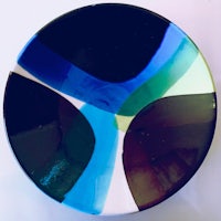 a plate with a blue, green, and black design