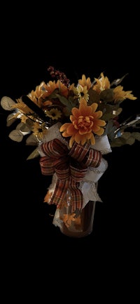 a bouquet of flowers in a vase on a black background