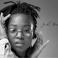 a black and white photo of a woman with glasses and dreadlocks