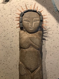 a statue of a woman with a sun on it