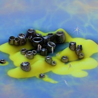 a group of black cylinders on a yellow background