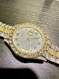 a gold and silver watch with diamonds on it