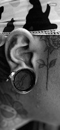 a man with a tattoo on his ear