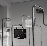 a black and white photo of a black and white bag hanging on a rack