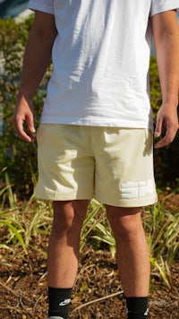 a man wearing a white t - shirt and shorts