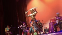 a woman performs a belly dance on stage