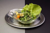 a salad on a plate with lettuce and tomatoes