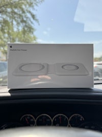 an apple airpods is sitting on the dashboard of a car