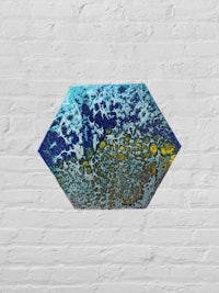 a blue and yellow painting on a brick wall