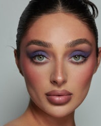 a model with purple eyeshadow and purple lips
