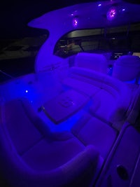 the interior of a boat is lit up with purple lights