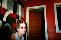 a woman wearing sunglasses in a room