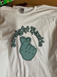 a white t - shirt with a green hand on it