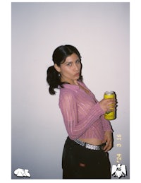 a woman holding a can of soda
