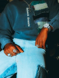a man wearing a blue sweatshirt and jeans