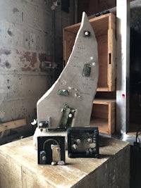 a sculpture of a boat sitting on a table in a workshop
