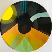 a plate with a black, yellow and orange design