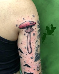 a tattoo of a mushroom on a woman's arm