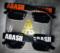 two pairs of sunglasses with the word abbasi on them