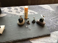a tray of rocks and a pencil on a table