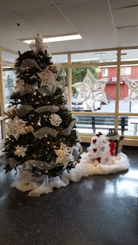 a christmas tree decorated with snowmen and snowflakes