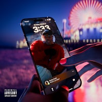 a hand holding a phone with a picture of a ferris wheel in the background