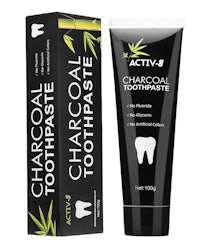a tube of charcoal toothpaste in front of a box
