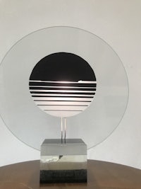a table lamp with a circular shape on top of it