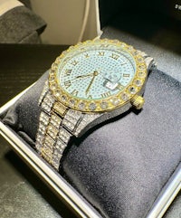 a gold and diamond watch in a box