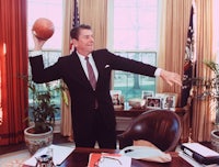 president ronald reagan holds a basketball in the oval office