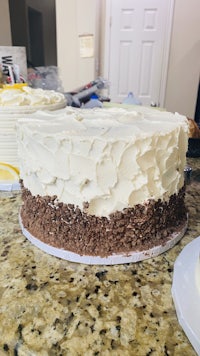 a white and chocolate cake on a counter top