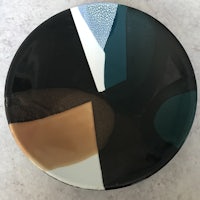 a plate with a black, brown, and green design
