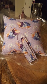 a pillow with a flower pattern on it is sitting on top of a table