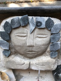 a stone sculpture with a face on it