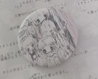 a button with a drawing of a girl and a boy