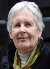 an older woman with gray hair and a green scarf