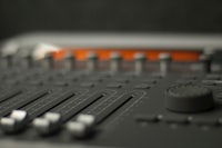 a close up of an audio mixing board