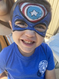 a young boy with a captain america face paint