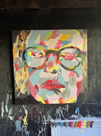 a painting of a man with glasses in front of a black wall