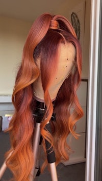 an orange and red wig on a mannequin