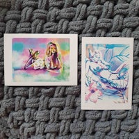 two watercolor prints of a woman laying on a blanket